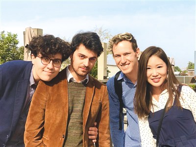 Four people posing together outdoors